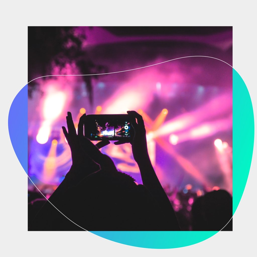 A man records a video of the concert.