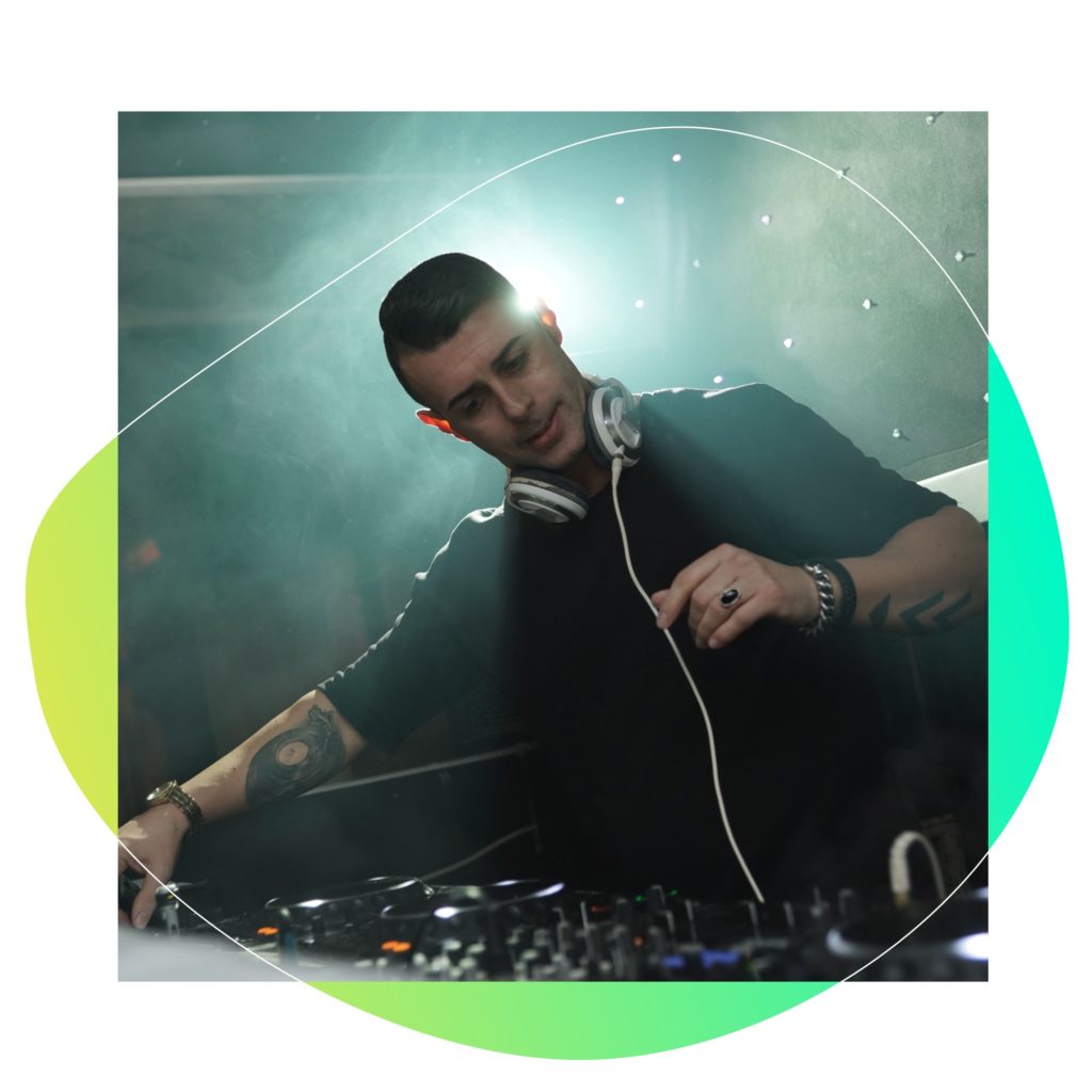 A DJ on the stage with his equipment and play his music