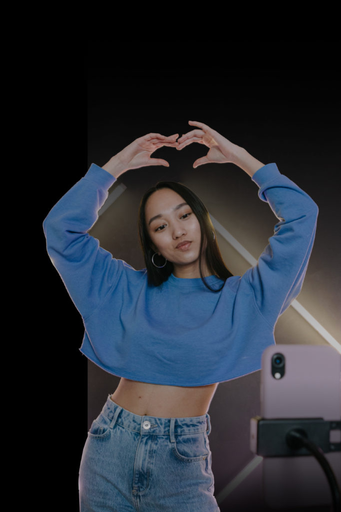 A girl is posing for a tiktok video